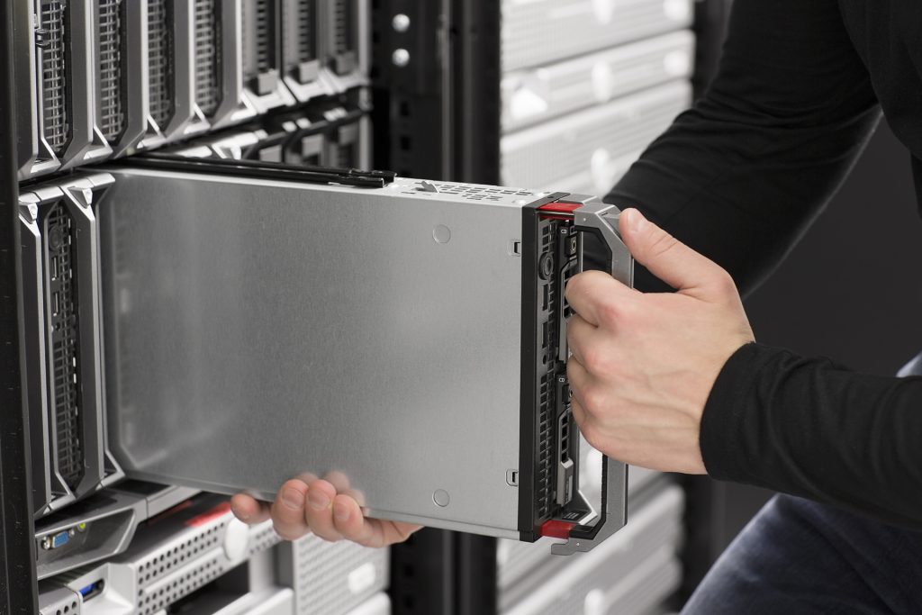 IT technician engineer install removes replace a blade server in a data center