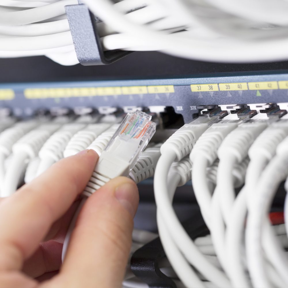 Technician plug in CPU microprocessor to motherboard socket. Workshop background